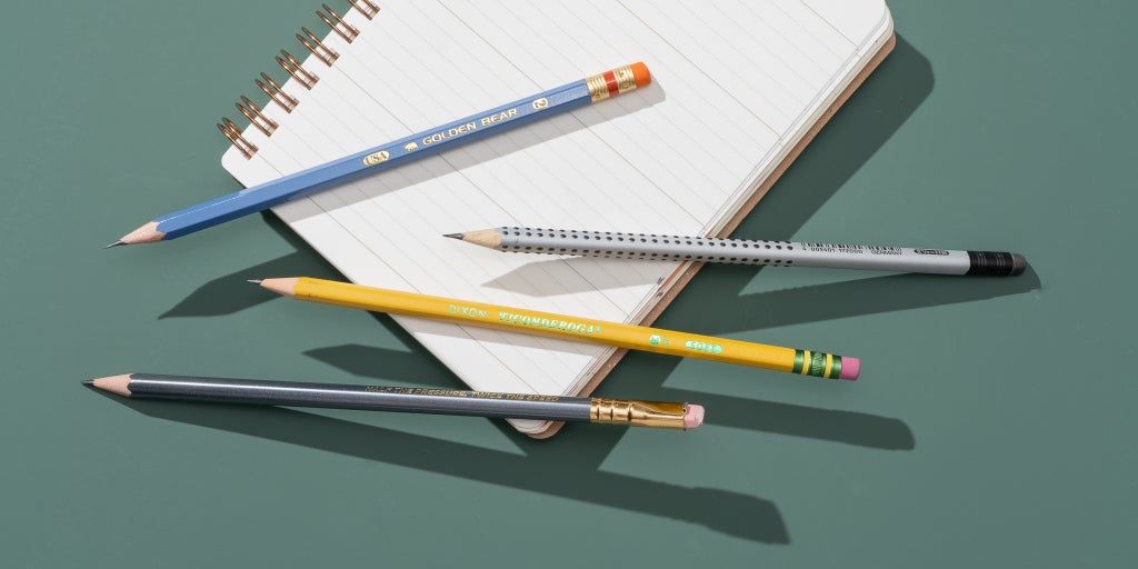 Our four picks for the best pencils for writing and schoolwork, shown laying on a spiral notebook.